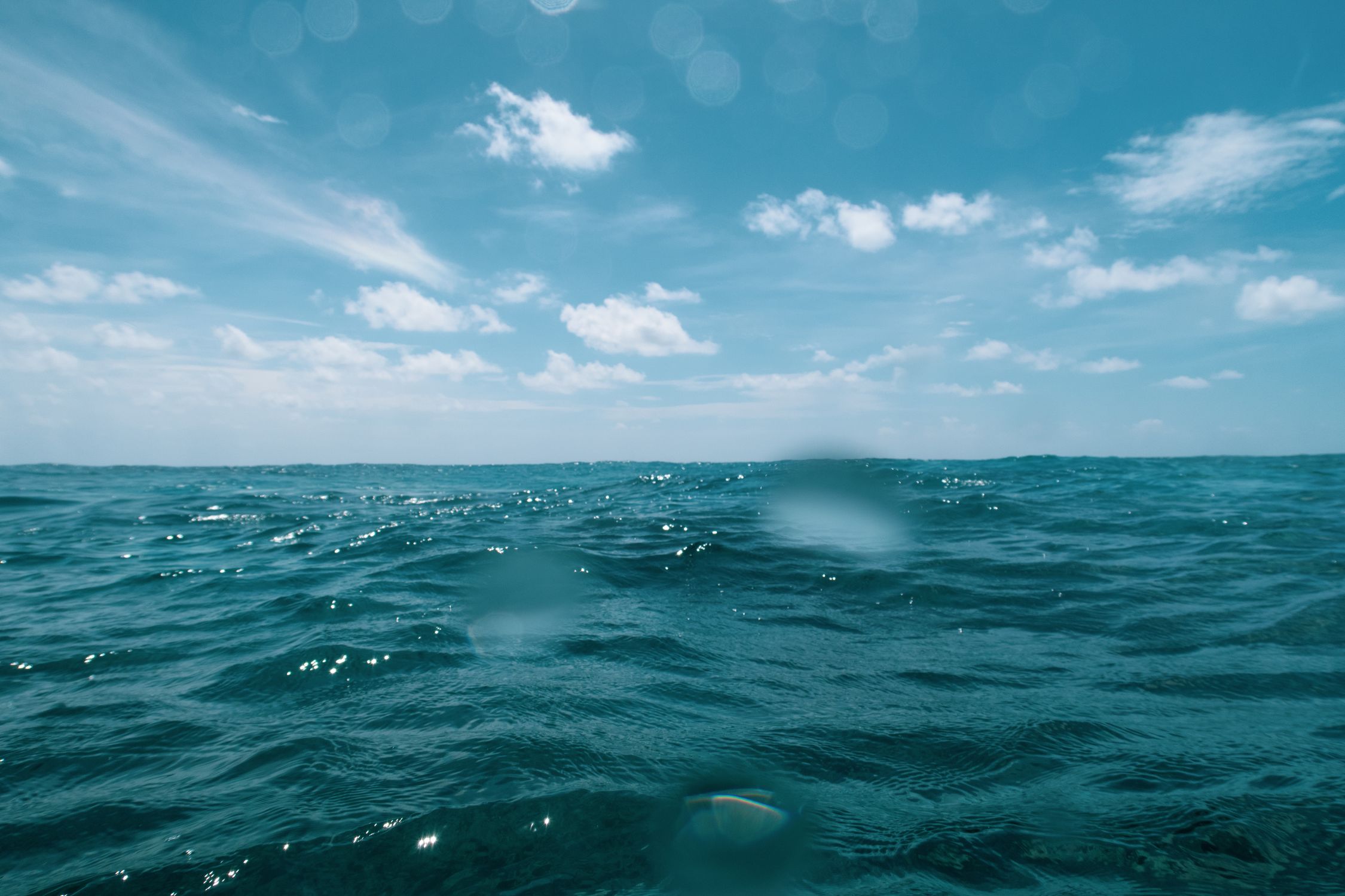 Ocean Under Blue Sky and White Clouds · Free Stock Photo