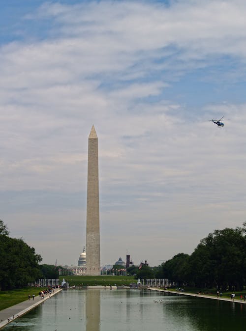 Free A Helicopter Flying Near Washington Monument Stock Photo