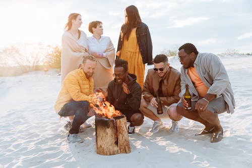 Group of Friends Heating Hands over Bonfire