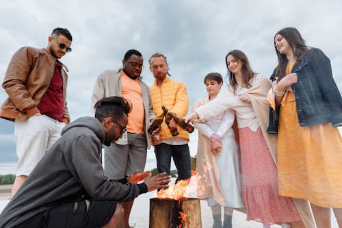 Free Standing Group Heating Hands over Bonfire Stock Photo