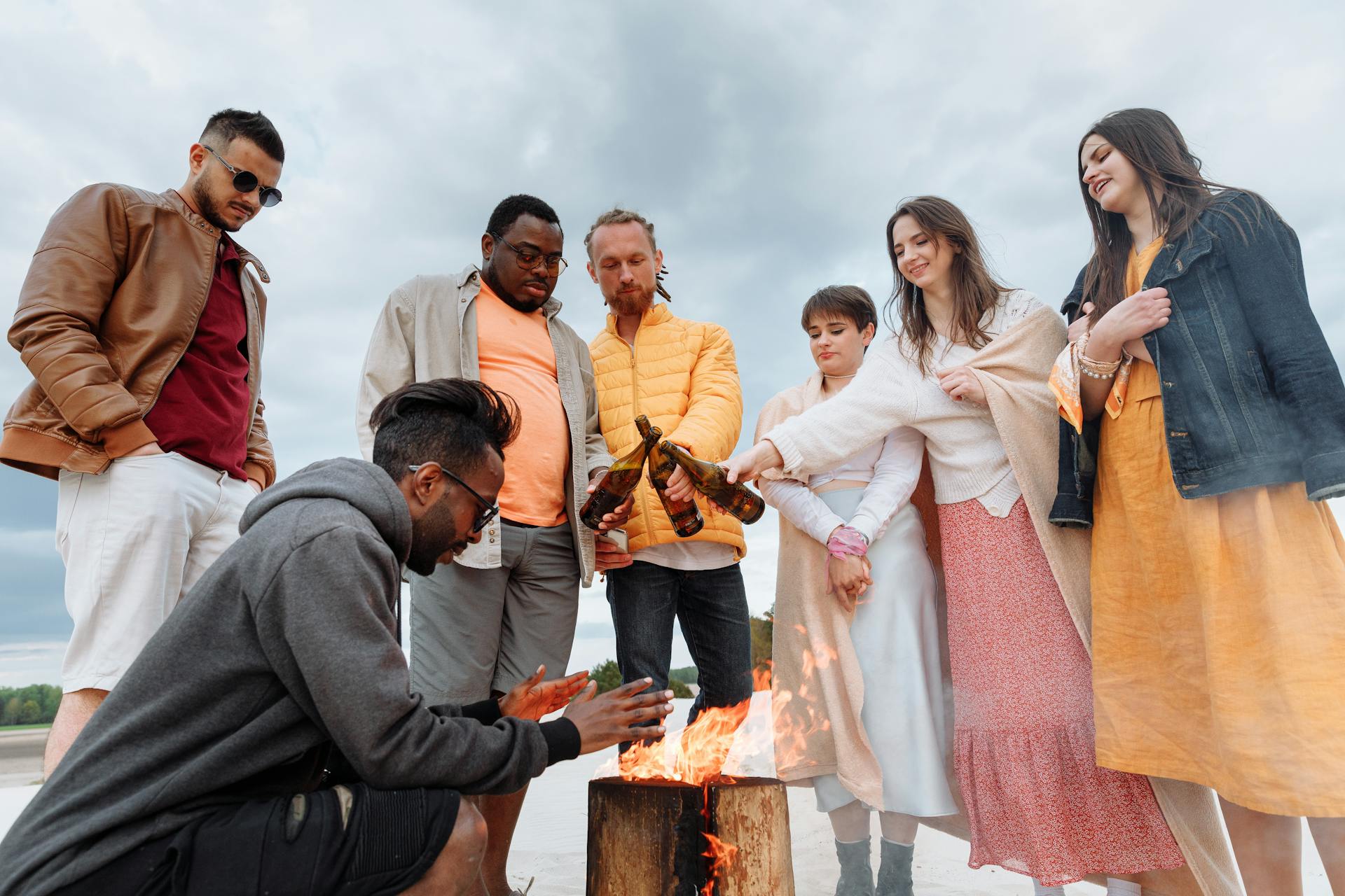 Standing Group Heating Hands over Bonfire