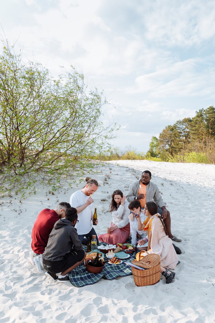 Group Of Friends Eating Together At A Picnic