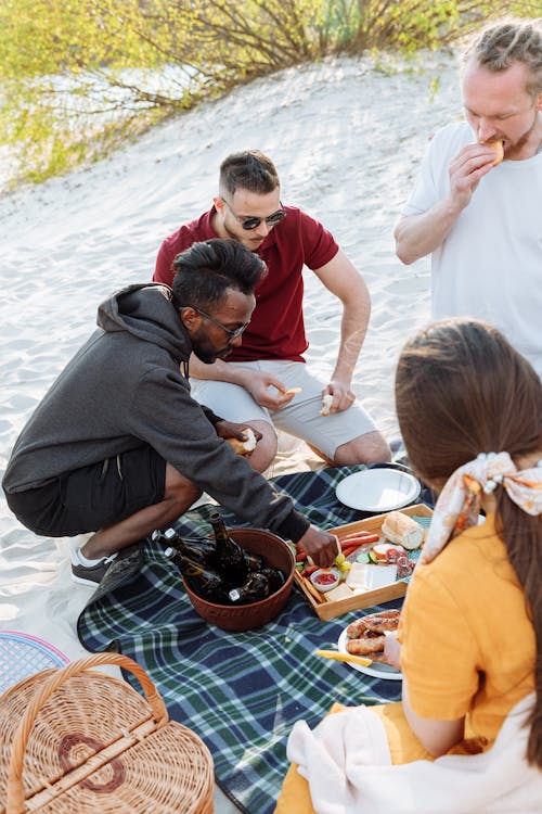 Free A Group of Friends Having a Picnic in the White Sand Stock Photo
