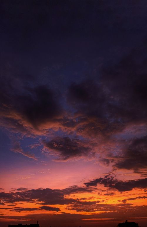 Free Vibrant sunset sky with dramatic clouds over Rajakhedi, India, creating a stunning twilight scene. Stock Photo