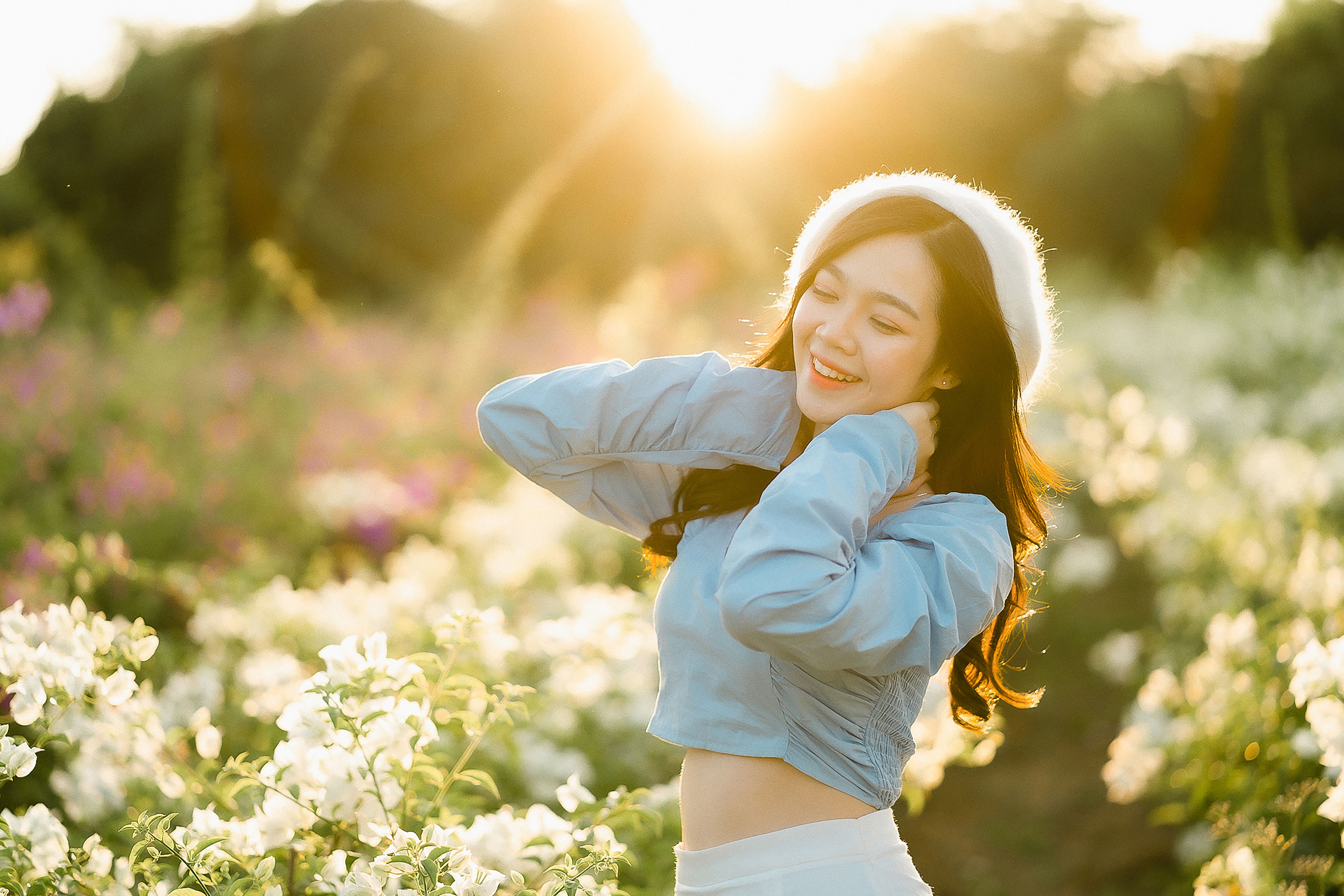 Photo of a Woman in a Red Dress Posing Near Red Flowers · Free Stock Photo