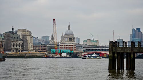 Photography Of Body Of Water Beside City Buildings