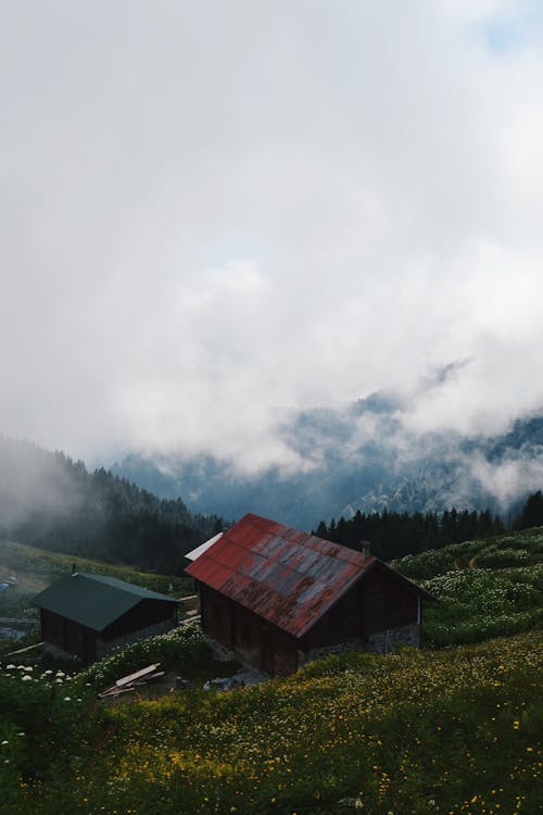 Two Houses in Mountains in Clouds