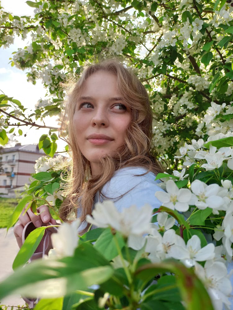 A Beautiful Woman Surrounded By Flowers