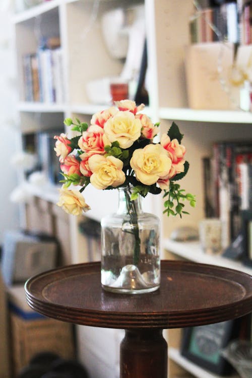 Arrange of Petal Flower in Clear Glass Vase at Table