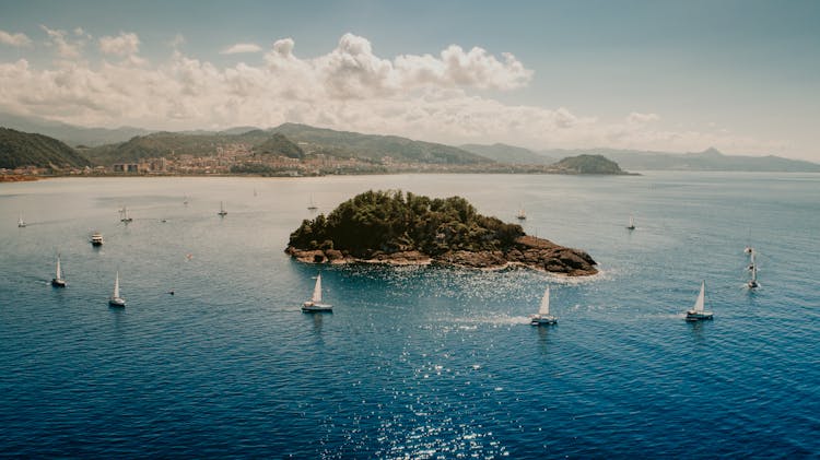 Boats Floating Around Island In Sea