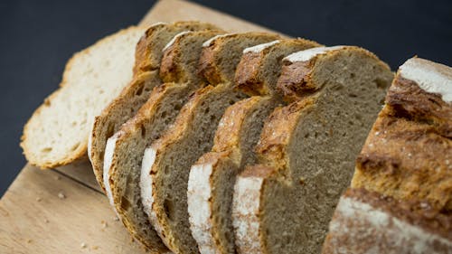 Free Sliced Brown Bread on a Wooden Board Stock Photo