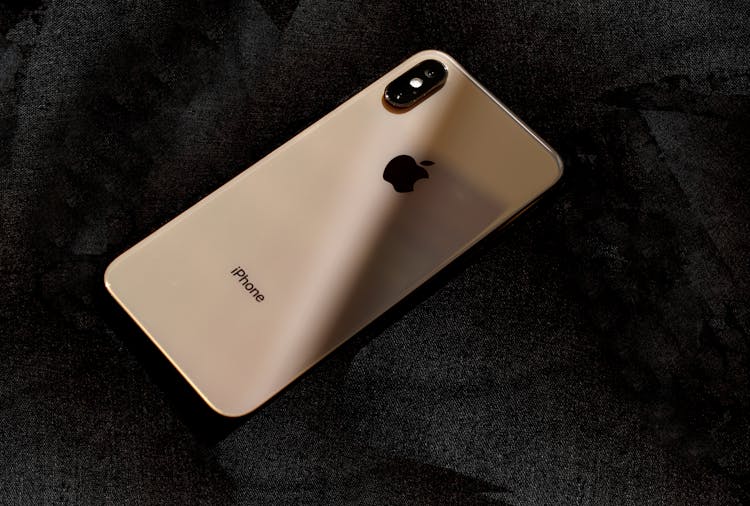 Back Design Of Gold Iphone Xs On A Black Surface