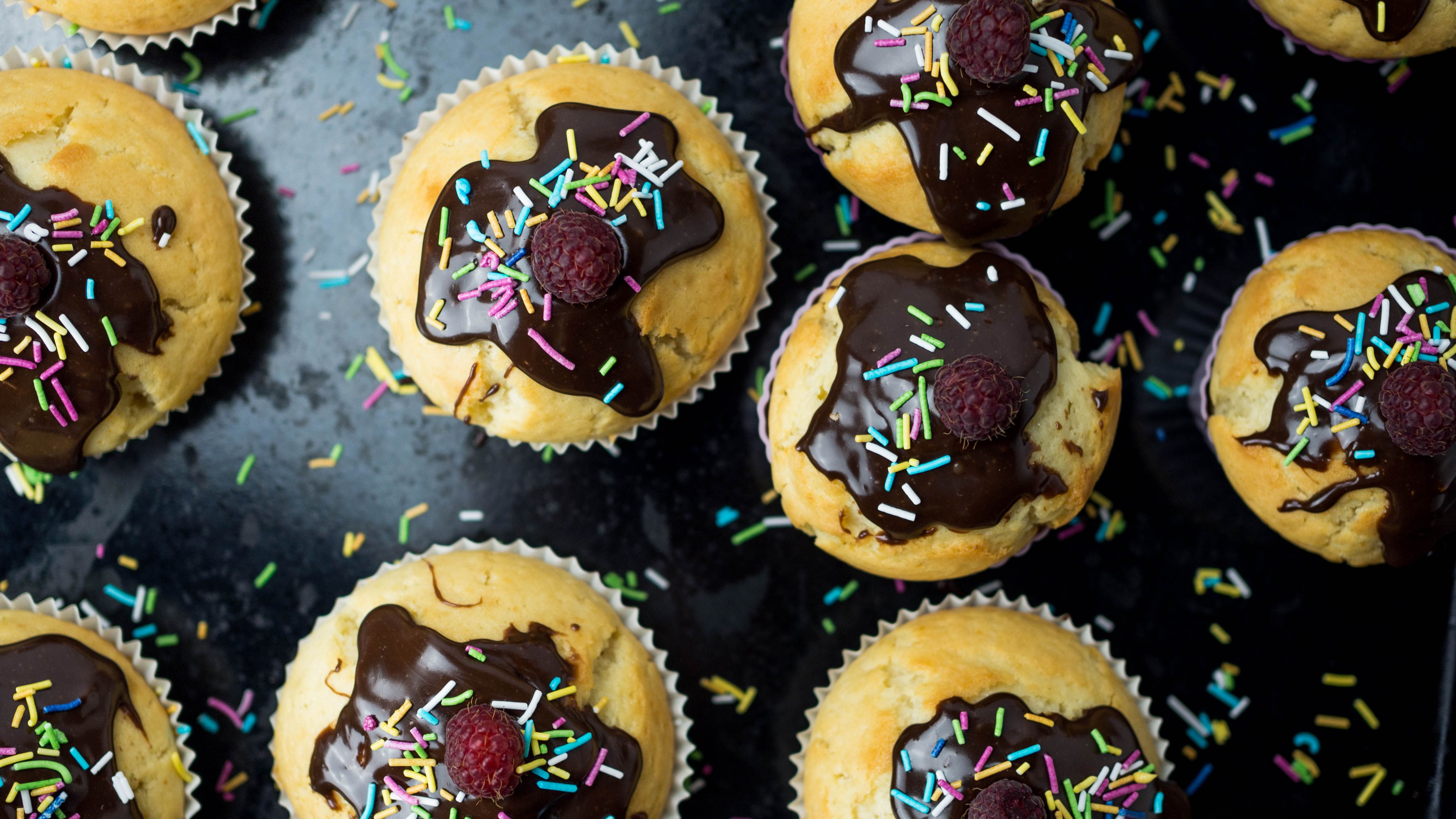 Top view of cupcakes with chocolate glaze and sprinkles, perfect for dessert lovers.