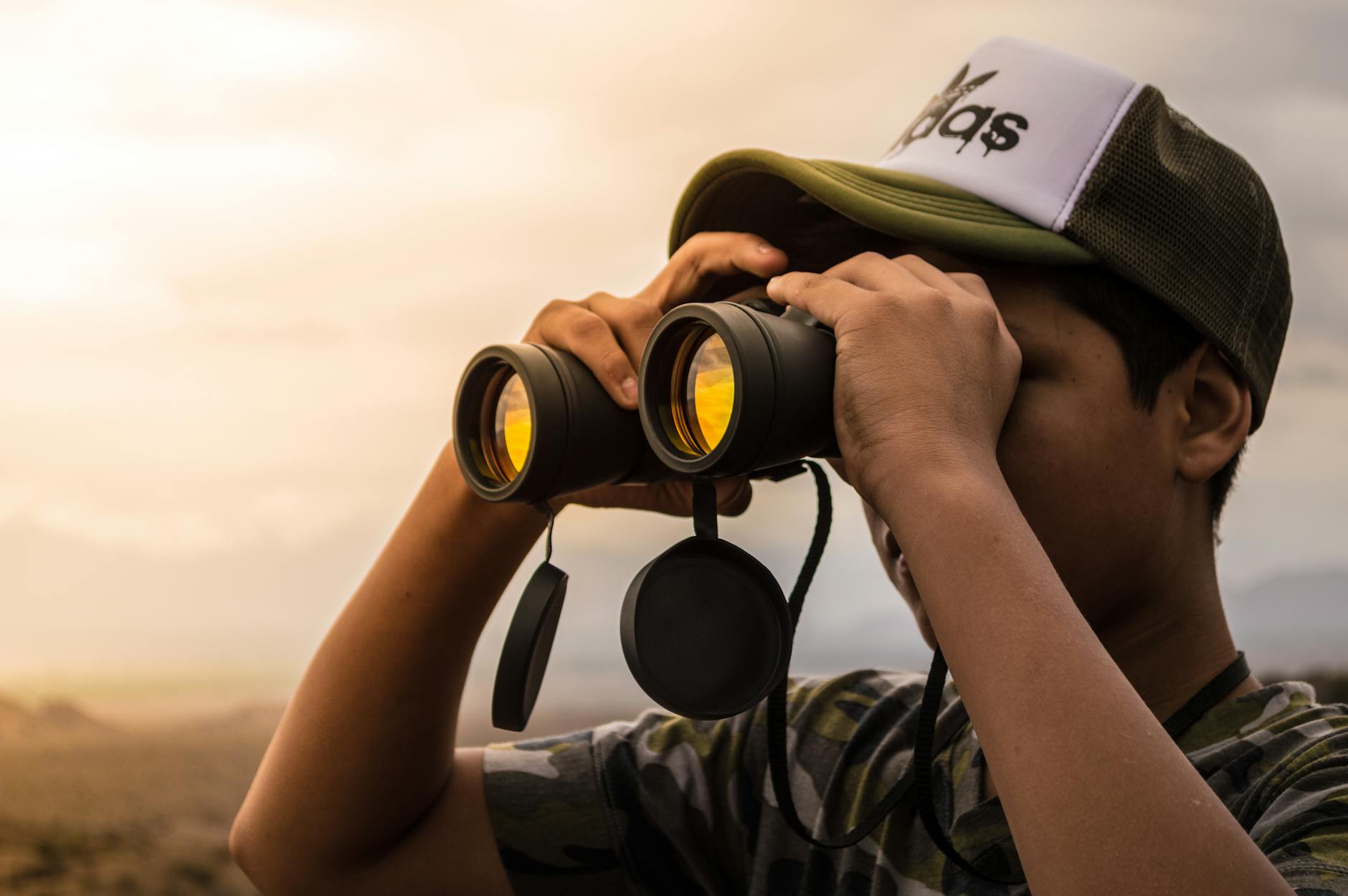 Man Looking in Binoculars during Sunset