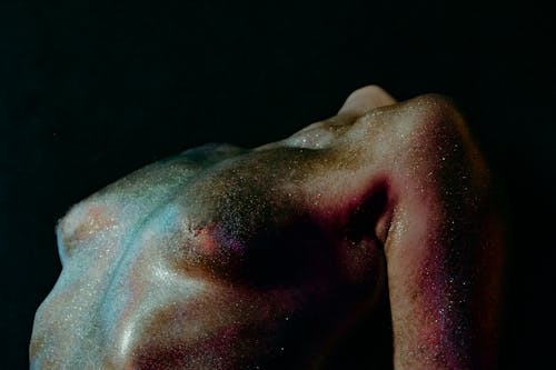 A Topless Person with Glitters on the Body