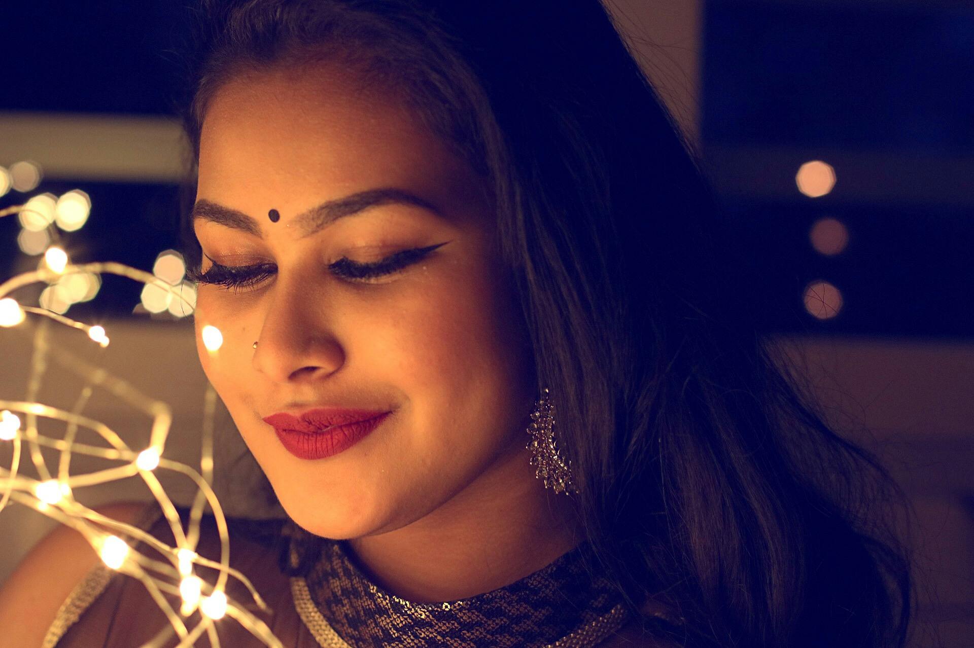 Free Photos - A Woman Wearing A Cultural Dress And A Bindi, Standing In  Front Of A Captivating Pink And Purple Light. She Appears To Be Staring  Into A Light Bulb, With