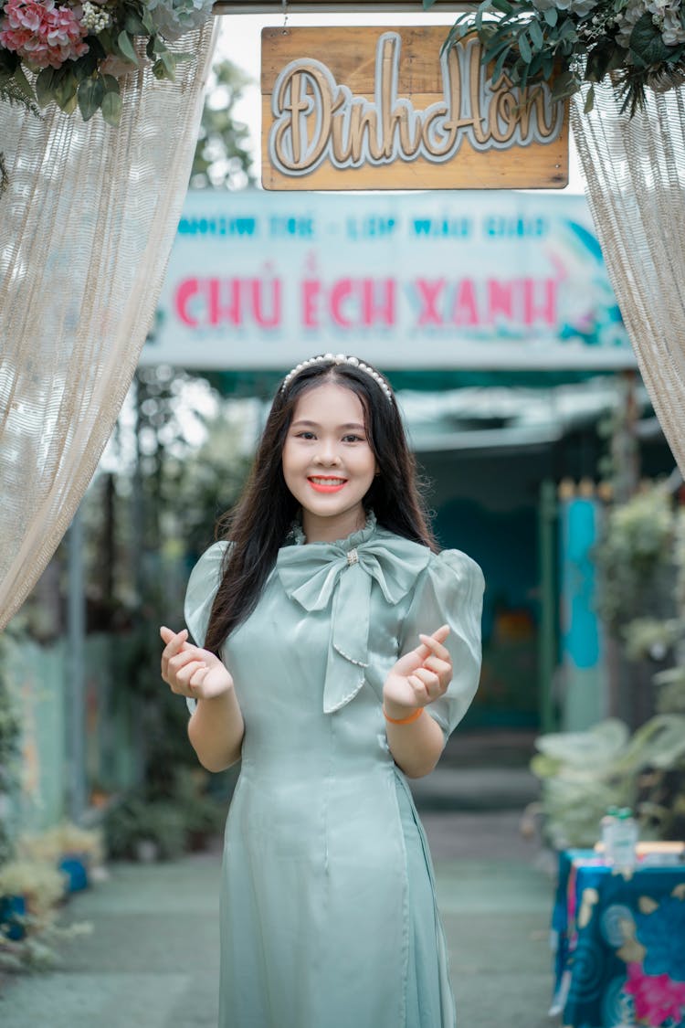 A Young Woman Doing A Finger Heart Gestures