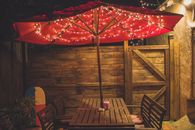 Photography of Red Patio Table With String Lights