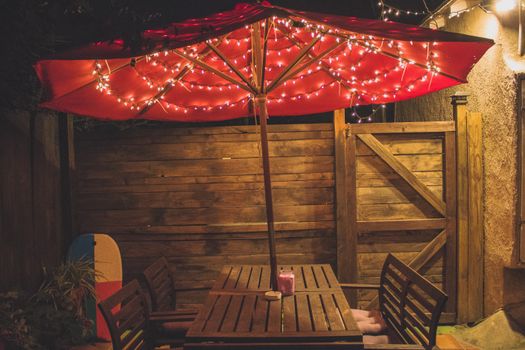 Photography of Red Patio Table With String Lights