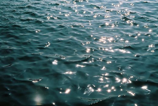 Sunlit water surface with shimmering reflections creating a calming effect.