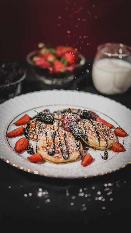 Pancakes with Powdered Sugar Dusting and Chocolate Syrup