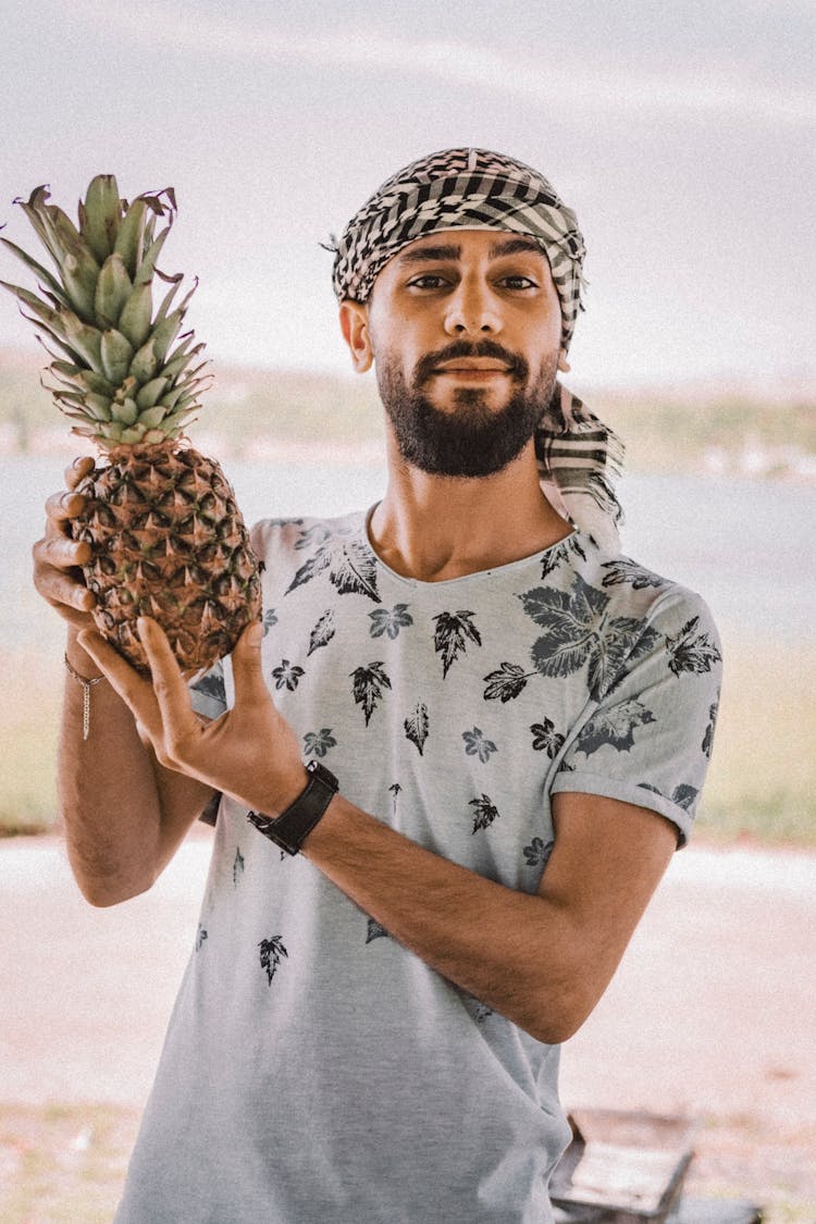 A Bearded Man Holding A Pineapple