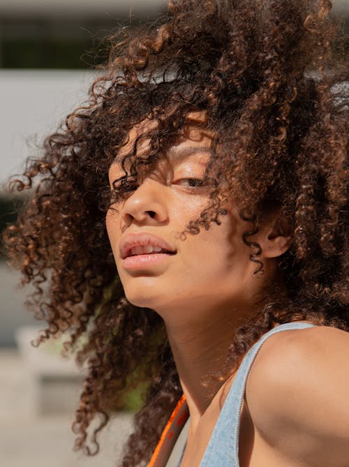 Close Up Photo of a Woman with Curly Hair