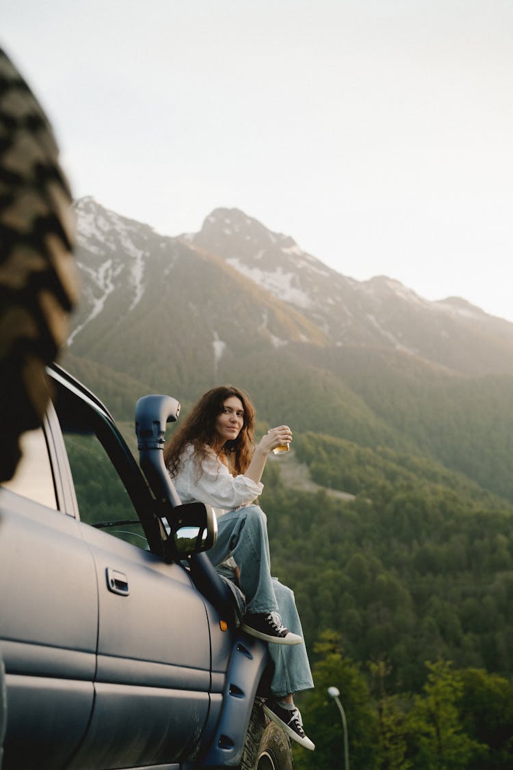 A Woman Sitting On The SUV