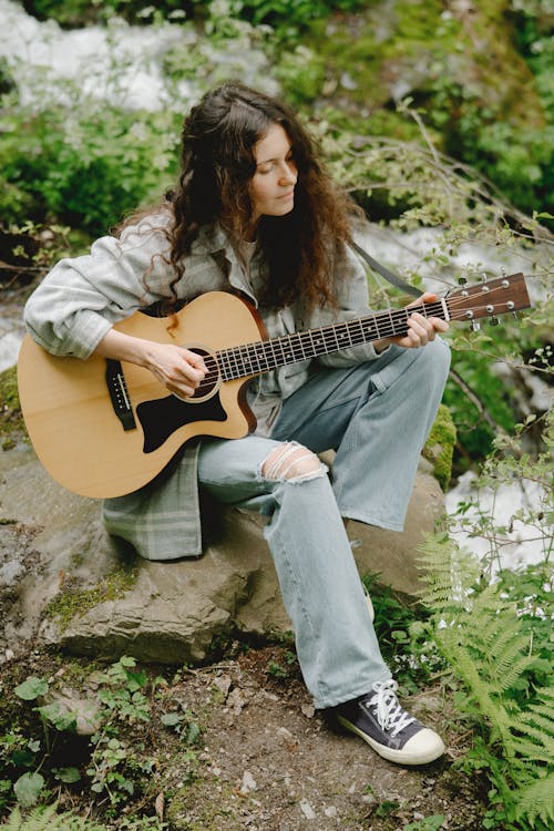 Woman playing an Accoustic Guitar 