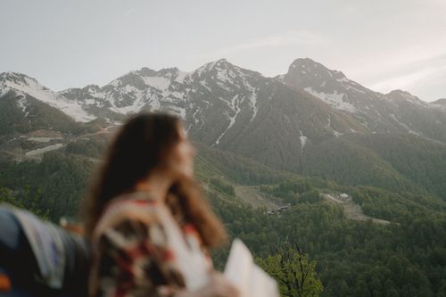 Free A tranquil scene featuring a blurred person gazing at picturesque mountains. Stock Photo