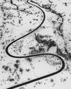Drone view of curvy road through winter terrain