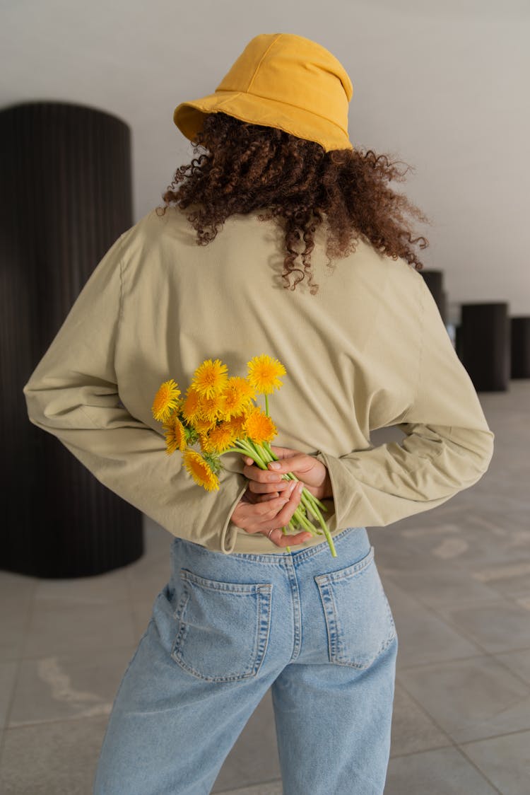 Back View Of A Woman Holding Flowers