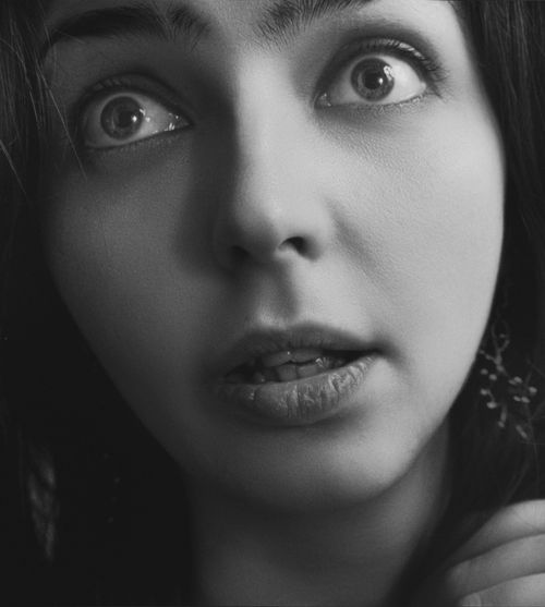 Free A striking black and white close-up portrait capturing intense facial expressions. Stock Photo