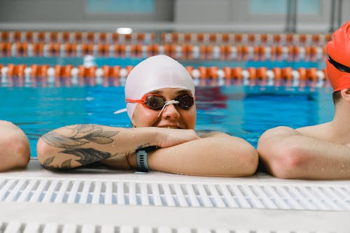 Person in a Swimming Pool Wearing Swimming Goggles and Swim Cap