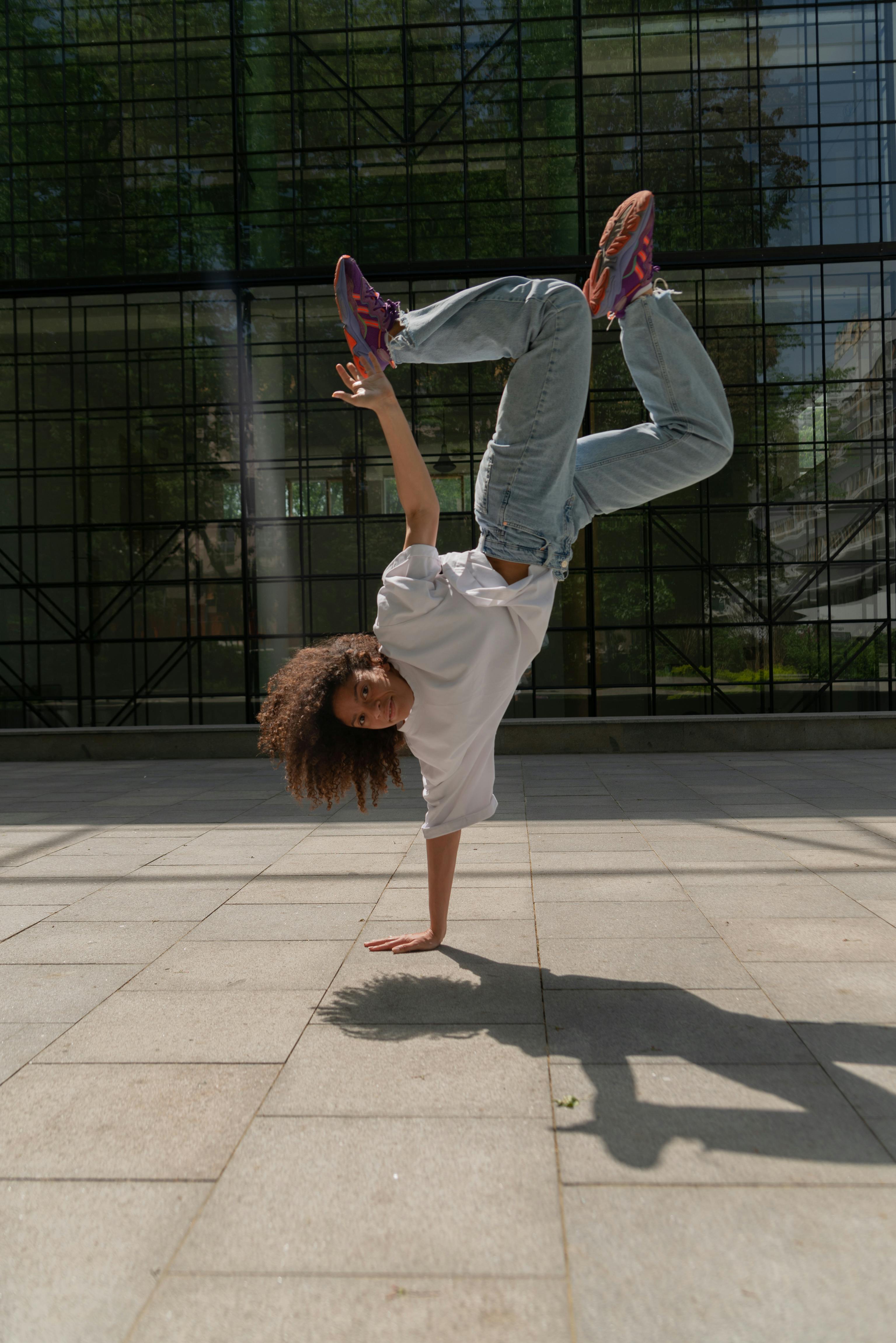 A Woman Doing a Hand Stand in a Break Dance · Free Stock Photo