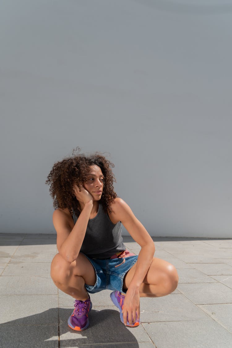 Woman With Curly Hair Crouching