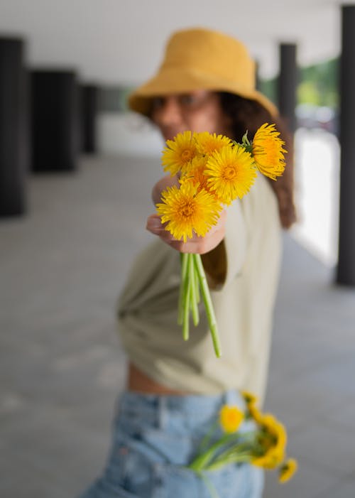 Woman Holding Yellow Flowers