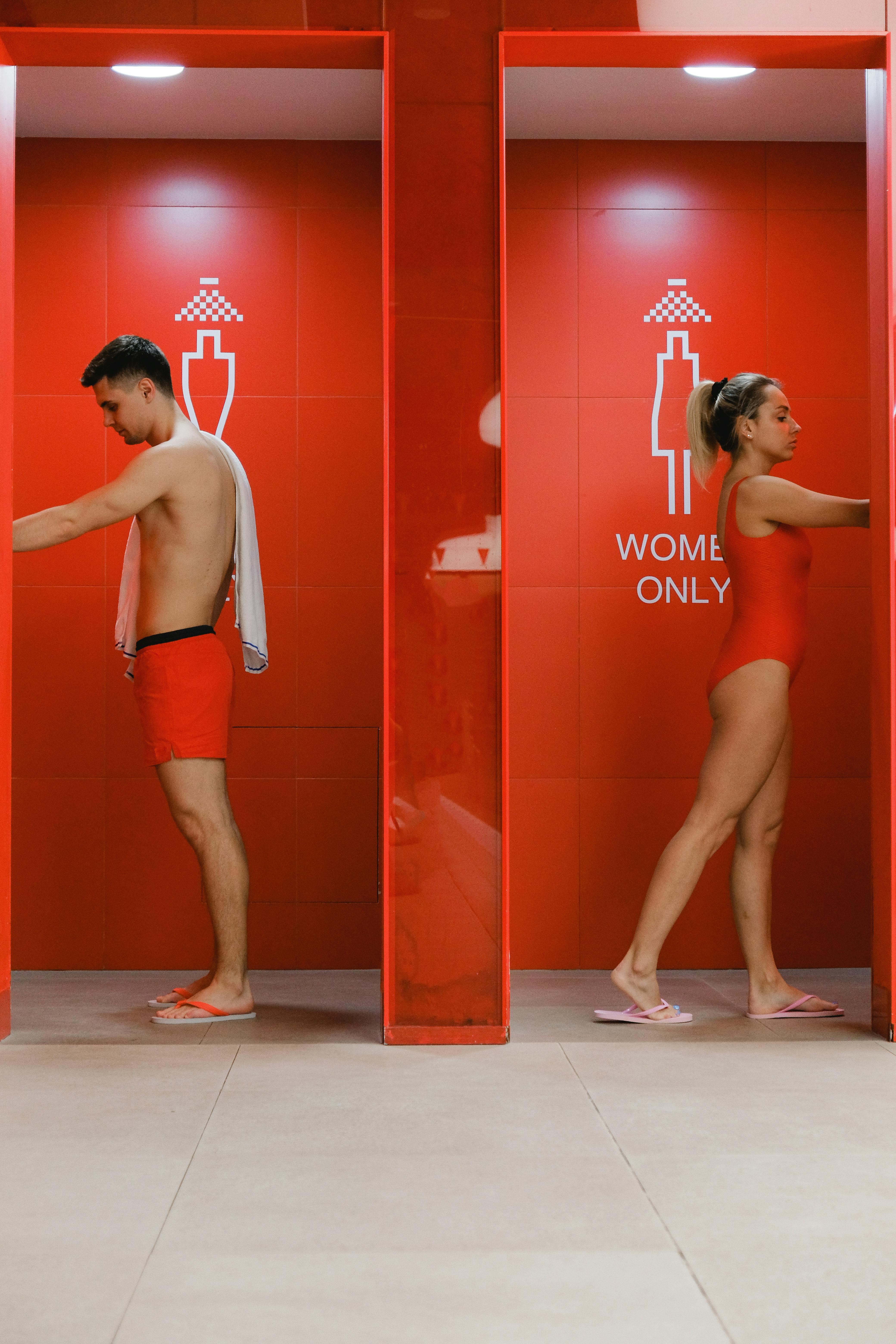 A Man and a Woman in Their Designated Shower Rooms · Free Stock Photo