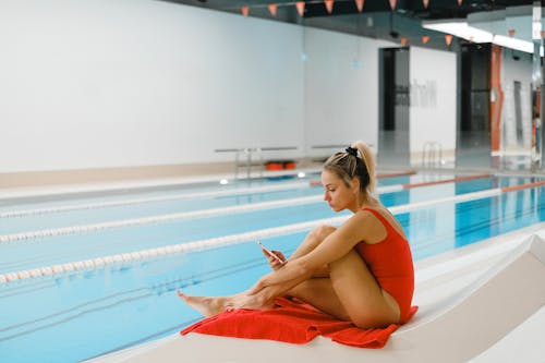 Free Woman Sitting by the Pool Stock Photo
