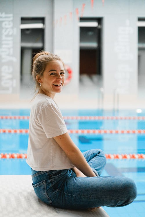 A Woman Sitting by the Swimming Pool