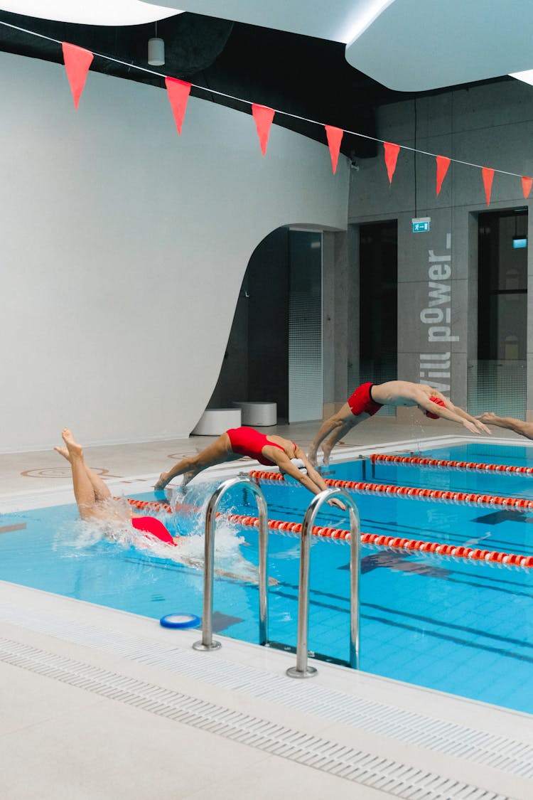 People Jumping Into The Swimming Pool