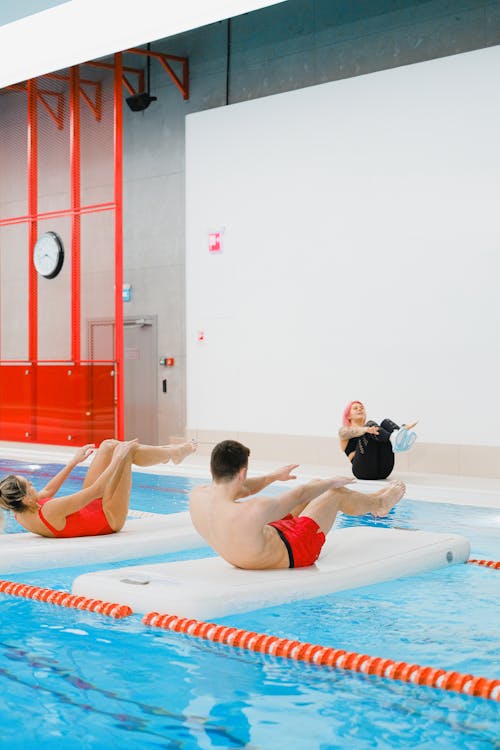 People Doing Exercise on the Swimming Pool
