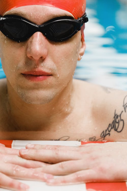 Wet Face of a Swimmer Wearing Goggles and Swimming Cap