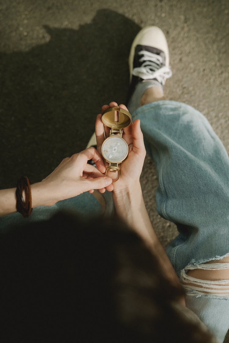 A Person Holding A Compass 