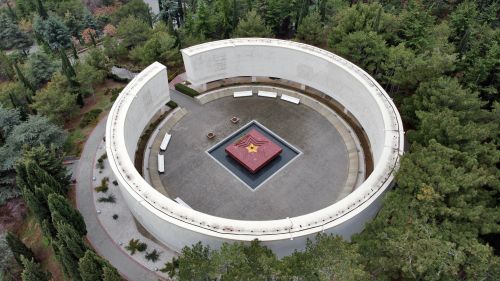 Free Aerial shot of a circular monument surrounded by trees featuring a star at its center. Stock Photo