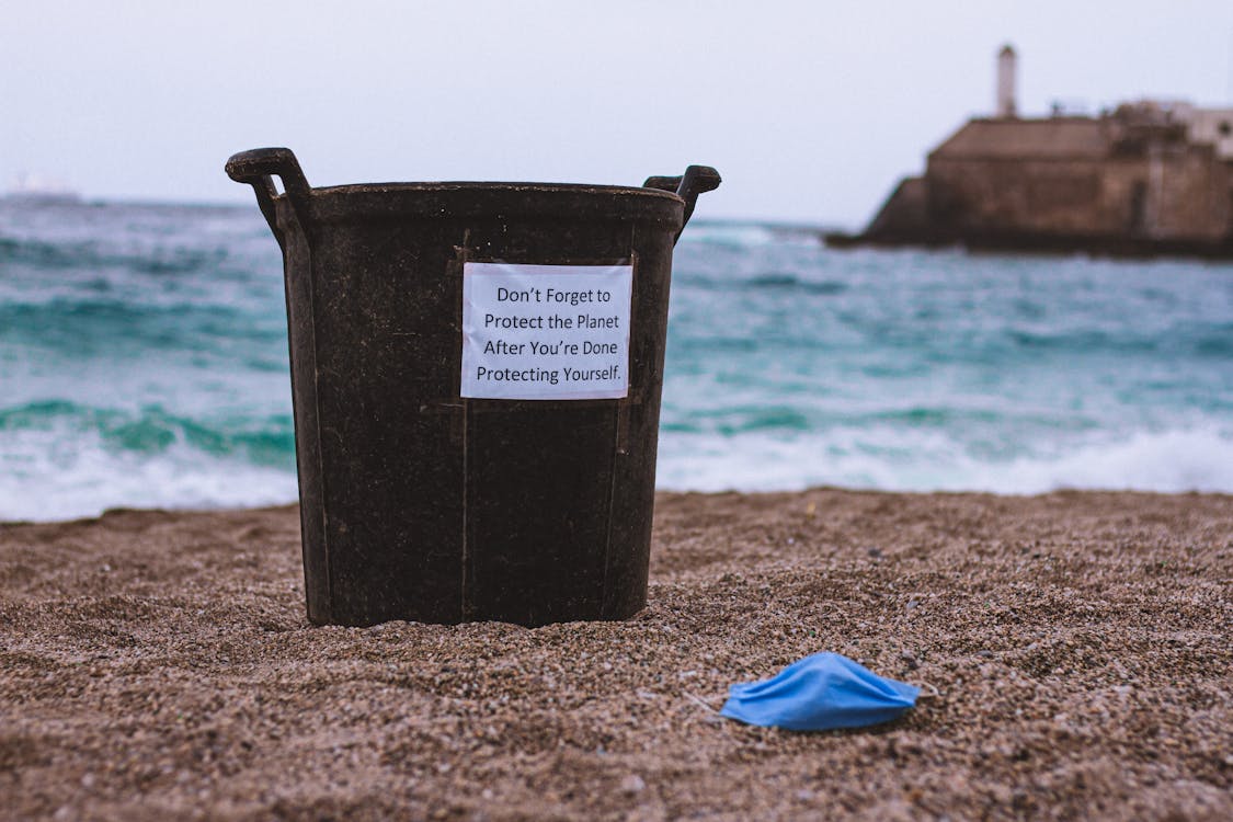 Black Bin on Brown Sand