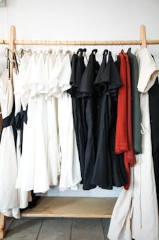 A stylish display of black, white, and red dresses hanging in a boutique, showcasing contemporary fashion.