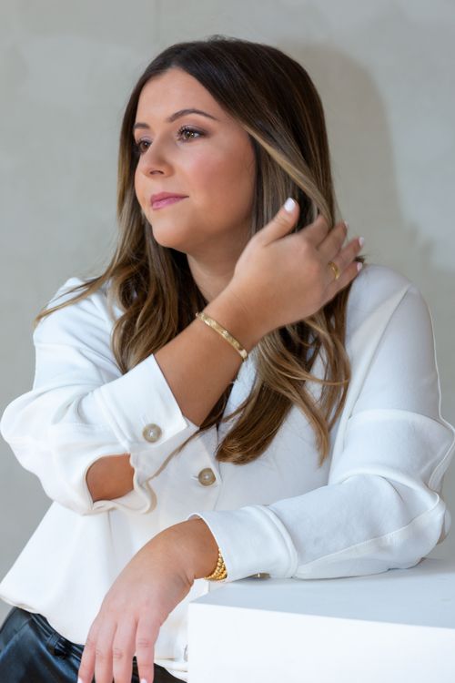 Free Stylish woman in a white blouse posing, exuding confidence and elegance. Stock Photo
