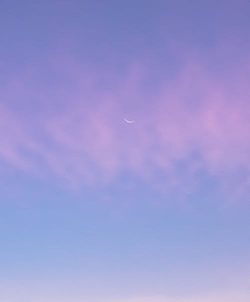 Free A Crescent Moon in the Purple Color Sky Stock Photo