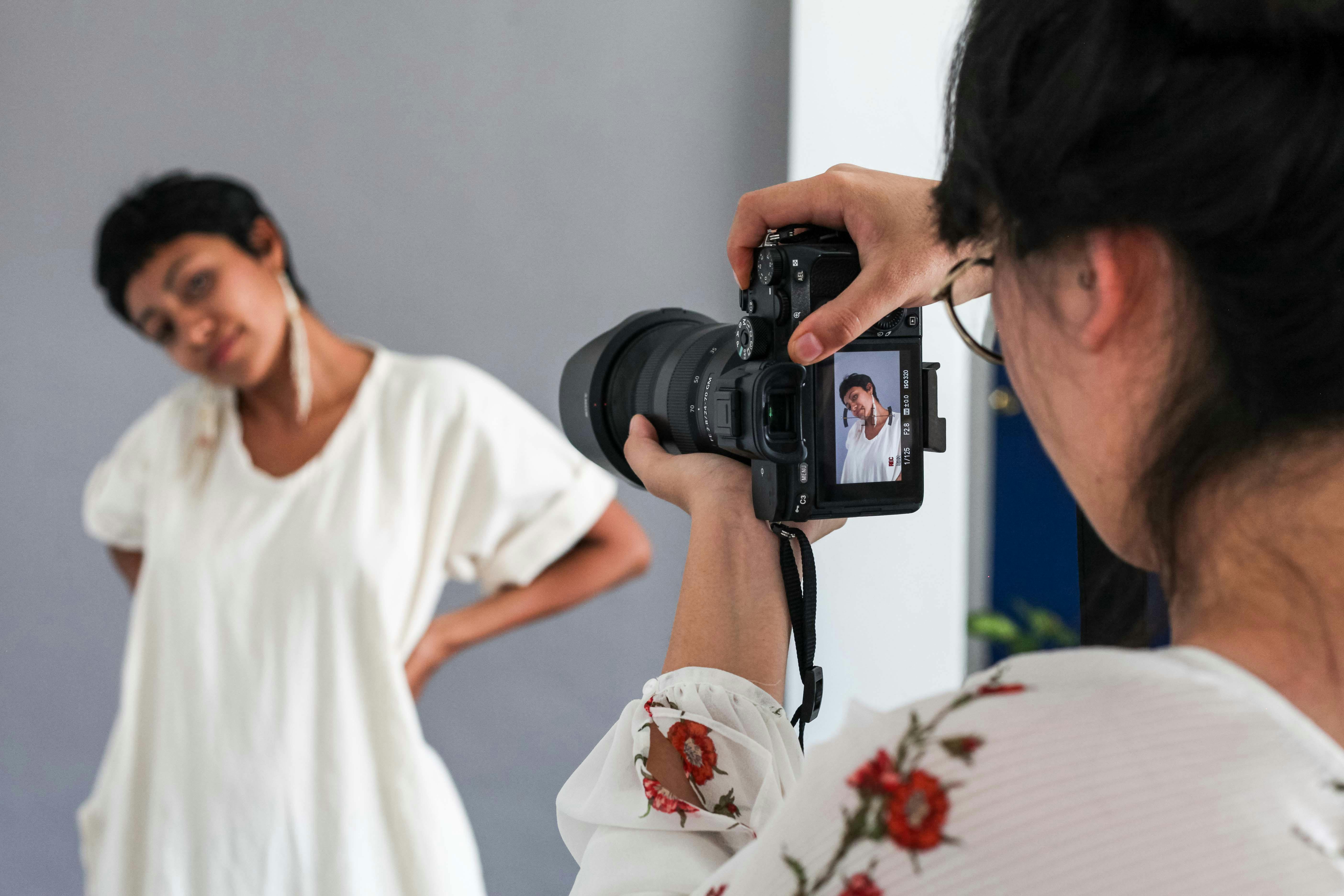 a person taking picture of a woman